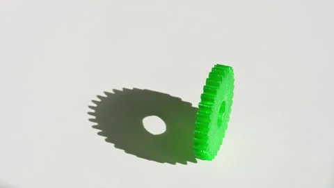 Green 3D Printed Plastic Gear Spinning on a White Background Stock Footage 314834625