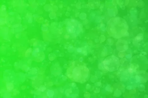 Green abstract defocused background, circle shape bokeh pattern. Stock Photos