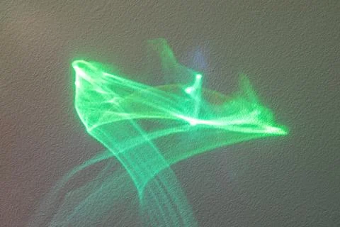 Green abstract light trail on textured wall creating futuristic motion and Stock Illustration