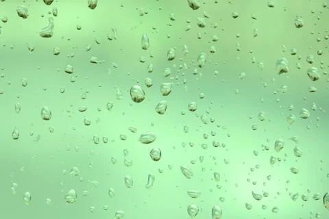 Green abstract rain drops on the window glass Stock Photos