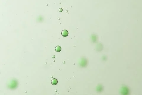 Green air bubbles flows over a blurred background 스톡 사진