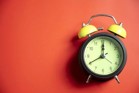 Green alarm clock on colored background. Empty area for copy space. Concept.. Stock Photos