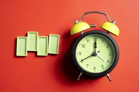 Green alarm clock with lime rectangular blocks on colored background. Empty.. 스톡 사진