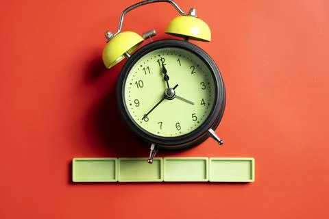 Green alarm clock with lime rectangular blocks on colored background. Empty.. 스톡 사진