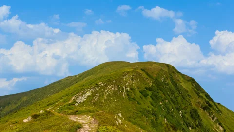 Green alone mount peak on cloudy sky background time lapse scene Stock Footage 172347123