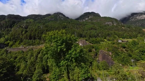 Green Alpine Valley with Forest and Dramatic Cloud Cover, Switzerland 4K Stock Footage 340900021