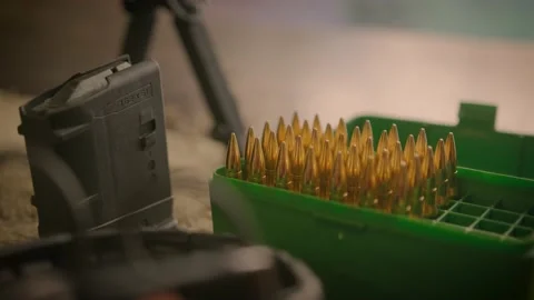 Green ammo case with shells and empty gun magazine at shooting range Stock Footage 146805806