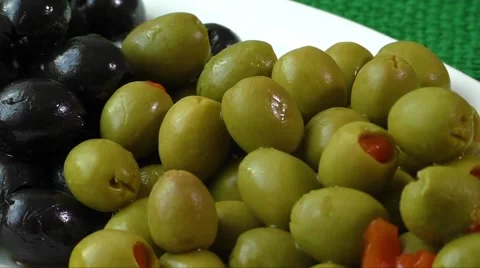 Green and black olives on a white plate Stock Footage 59883745
