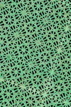 A green and black patterned fabric with a lot of small green dots Foto stock