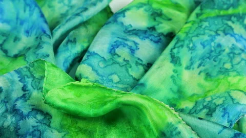 Green and blue abstract pattern silk fabric gently falls in slow motion. Stock Footage 337404303