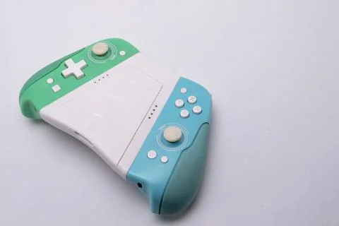 Green and Blue Game Controller on White Background, Gaming Device, Modern T.. Stock Photos