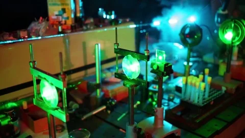 Green and blue lasers in optic assembly in smoke in dark in laboratory. Stock Footage 69988268