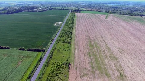 Green and brown fields in british countryside from above via drone Stock Footage 88737357