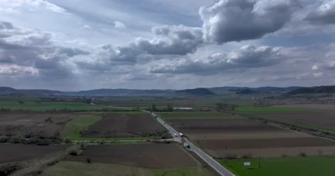 Green and brown rural fields with blue sky in the summertime in Romania Stock Footage 201489295