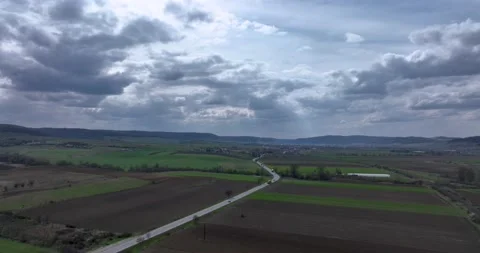 Green and brown rural fields with blue sky in the summertime in Romania Stock Footage 201489395