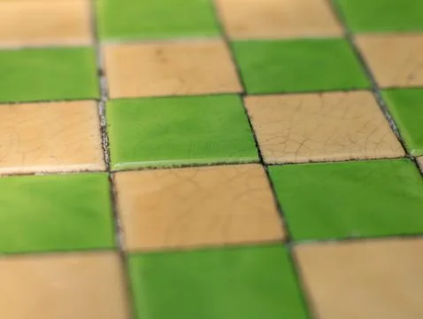 Green and Cream Checkered Ceramic Tile Floor Pattern Close-Up Texture Stock Photos