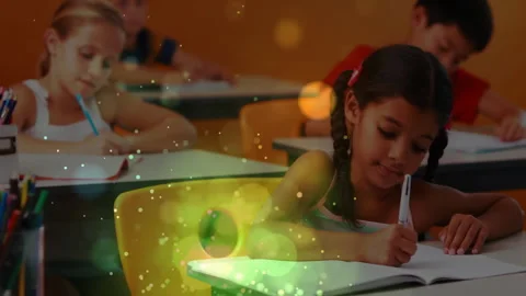 As green and gold particles drifting across classroom students writing notebooks Stock Footage 312280475