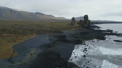 Green and high cliffs by the sea in a volcanic area in Iceland. Stock Footage 225863062