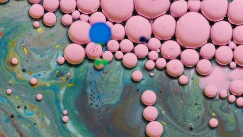 Green and pink inks react to form a beautiful structure of paint bubbles. Stock Footage 121223313