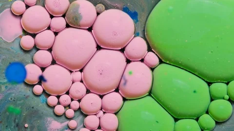 Green and pink inks react to form a beautiful structure of paint bubbles. Stock Footage 121223337