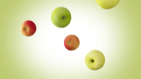 Green and red apples falling down in slow motion on green background. Stock Footage 252361803