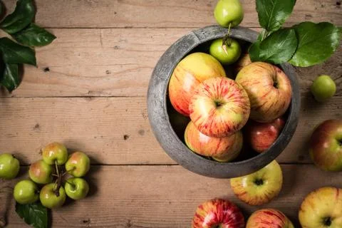 Green and red apples on rustic  table . Top view Stock Photos