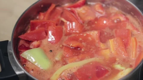 Green and red capsicums, cut in large slices boiling in the pot. Food Stock Footage 322065662