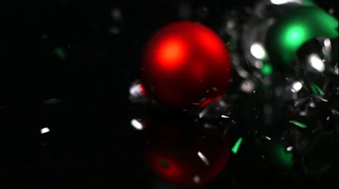Green And Red Christmas Ornaments Shatter On Black Background In Slow Motion Video stock 59669141