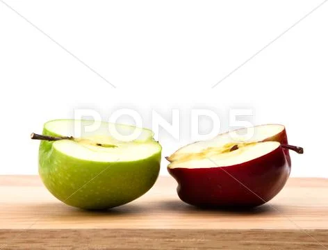 Green and red half of apple Stock Photos