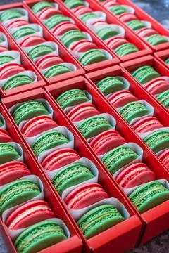 Green and red Macaron in red boxes Stock Photos