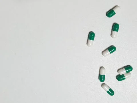 Green and white capsules Stock Photos