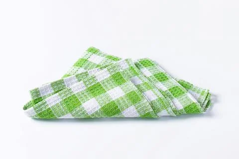 Green and white checkered folded cloth napkin Foto stock