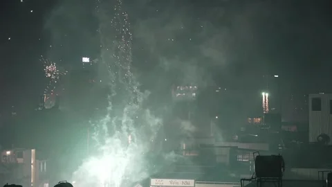 Green and White Fireworks Explosion over City building silhouettes Stock Footage 339638287