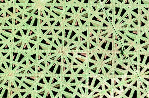 A green and white patterned surface with a lot of triangles Stock Photos
