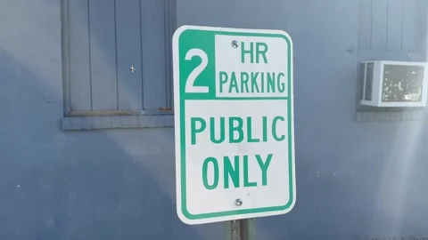 A green and white two hour parking sign Stock Footage 346644185