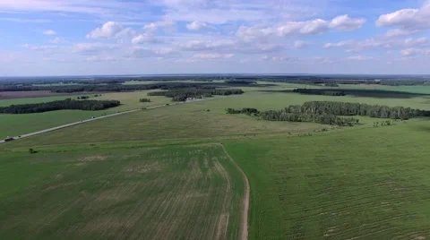 Green and yellow fields and highway. Aerial top view Stock Footage 64220458