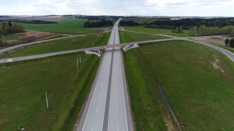 Green and yellow fields around the highway, aerial shot Stock Footage 86156912