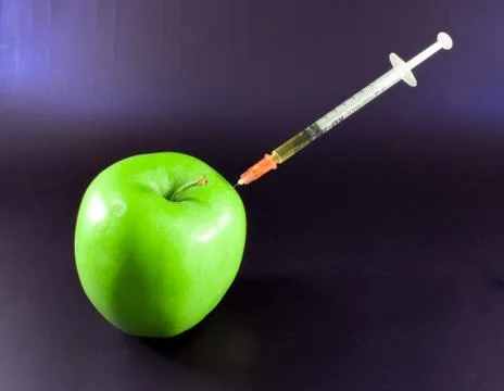 Green Apple and Hypodermic Poison Syringe. Stock Photos