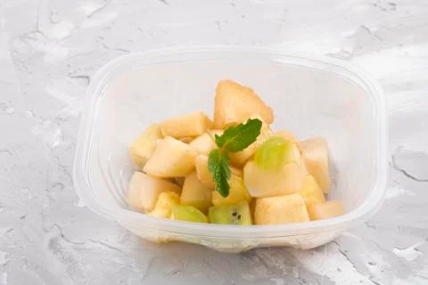 Green apple and mint leaf salad with condensed milk in food container Stock Photos