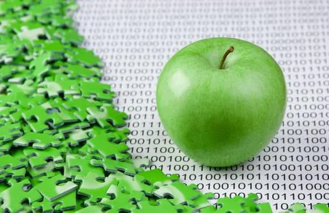 Green apple and puzzles on a binary code Stock Photos