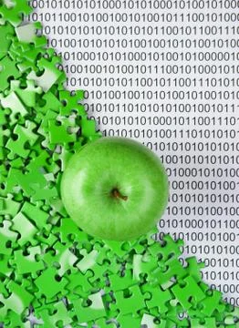 Green apple and puzzles on a binary code Stock Photos