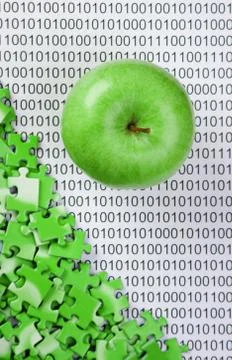 Green apple and puzzles on a binary code Stockfoto's