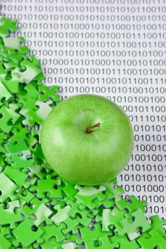 Green apple and puzzles on a binary code 스톡 사진