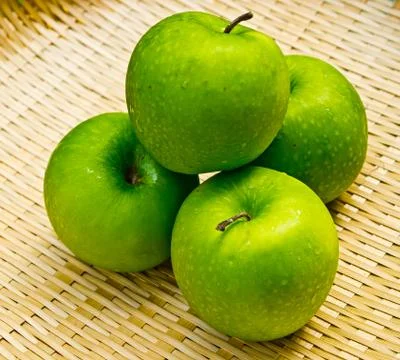 Green apple on basket work Stock Photos
