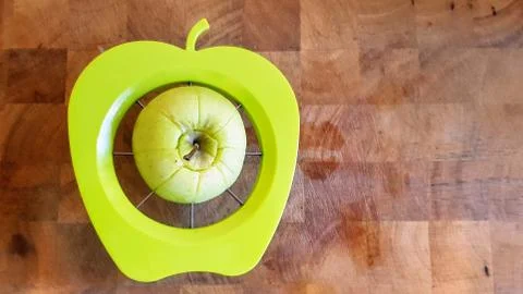 A green apple being separated into chunks Fotos Stock