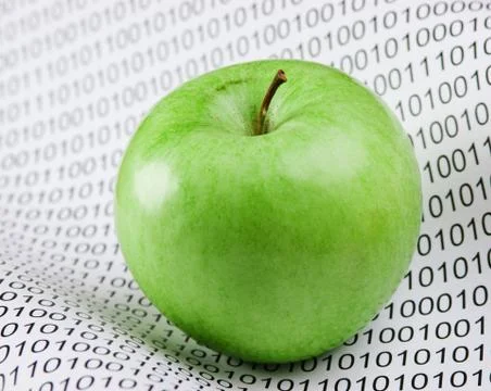Green apple on a binary code Stockfoto's