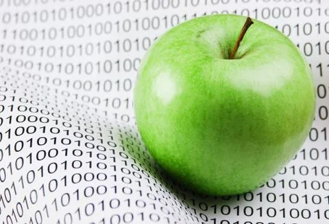Green apple on a binary code Stockfoto's