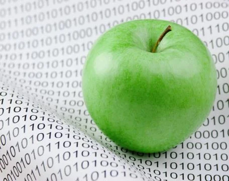 Green apple on a binary code 写真素材