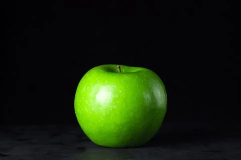 Green apple on a black background Stock Photos