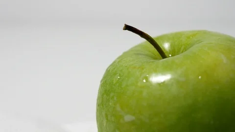 Green apple closeup cropped, splashed with drops of water Stock Footage 99262260